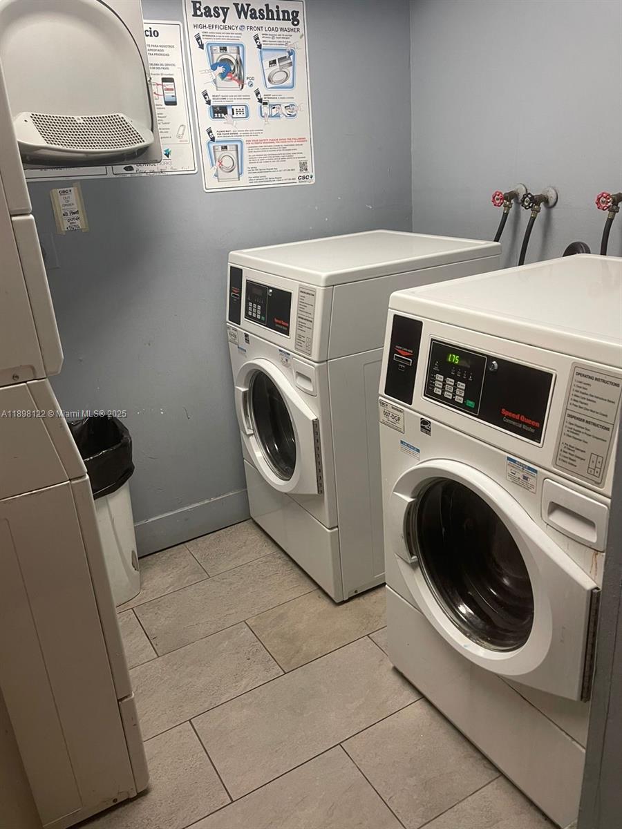 492 Northwest 165th Street, Unit C512 Miami, FL 33169 - Photo 23 of 27 a utility room with dryer and washer