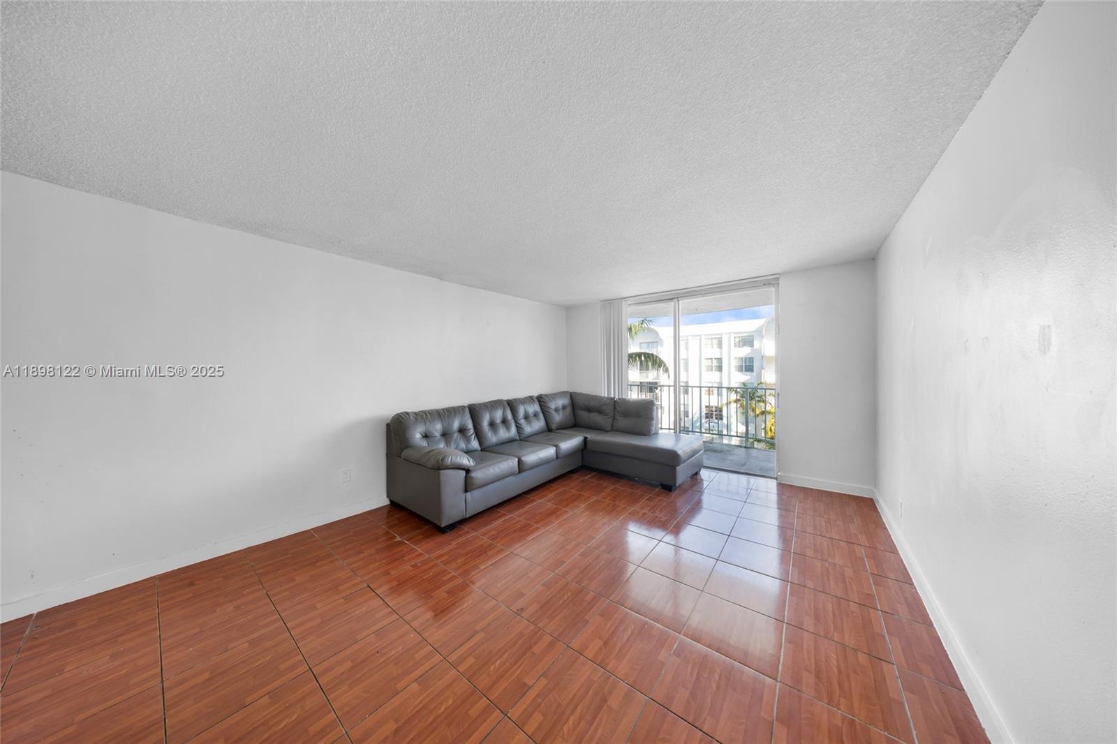 492 Northwest 165th Street, Unit C512 Miami, FL 33169 - Photo 5 of 27 a living room with furniture and a window