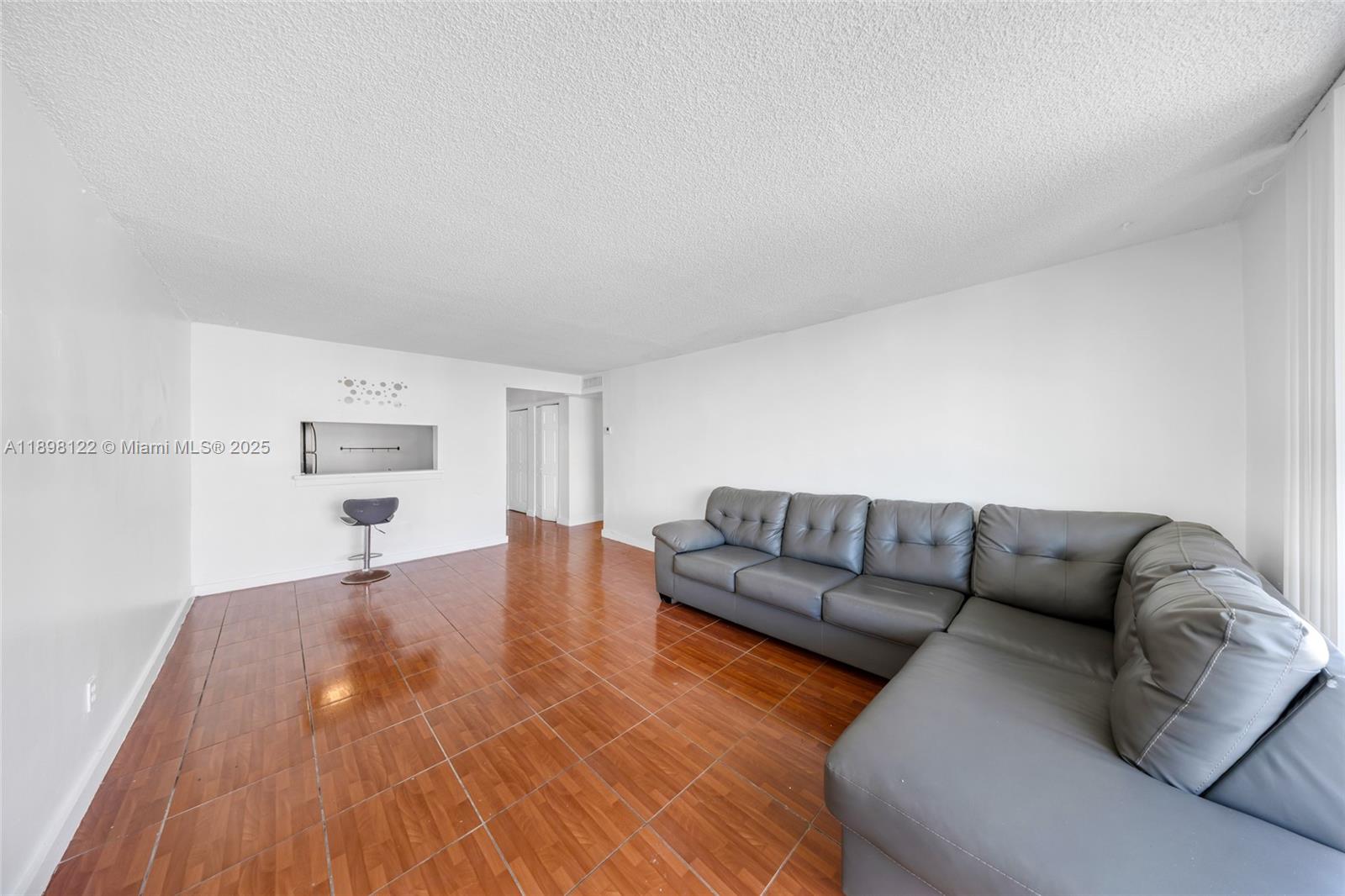 492 Northwest 165th Street, Unit C512 Miami, FL 33169 - Photo 6 of 27 a living room with furniture and a wooden floor