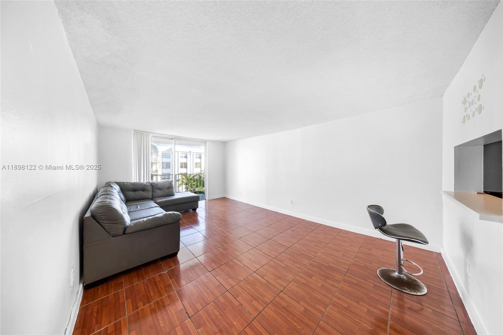 492 Northwest 165th Street, Unit C512 Miami, FL 33169 - Photo 8 of 27 a living room with furniture and a window