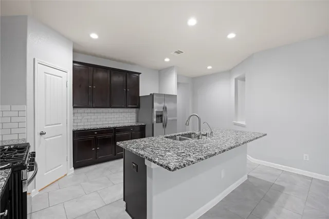 a kitchen with a stove and a refrigerator
