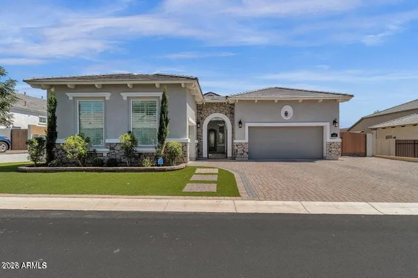 a front view of a house with a garden and yard