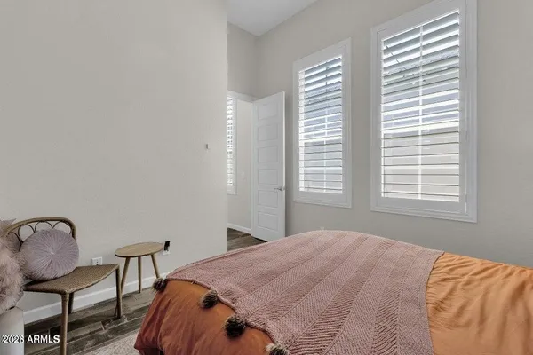 a bedroom with a bed chair and a window