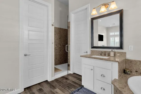 a bathroom with a toilet a sink a vanity and mirror