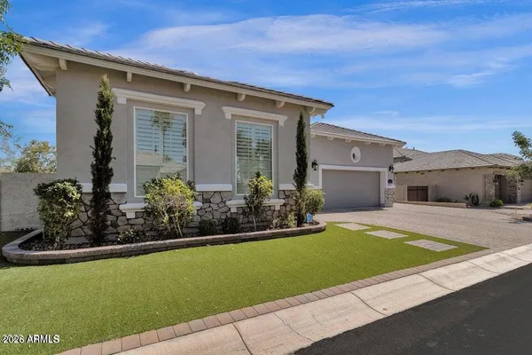a front view of a house with a garden