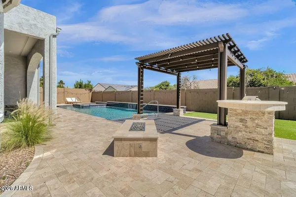 a view of a patio with a table and chairs