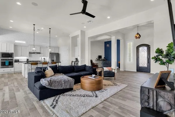 a living room with furniture and a view of kitchen
