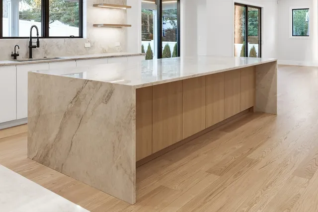 a bedroom with a large bed and a large window