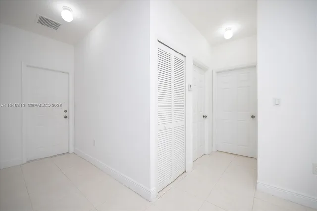 a large kitchen with a stove and a refrigerator