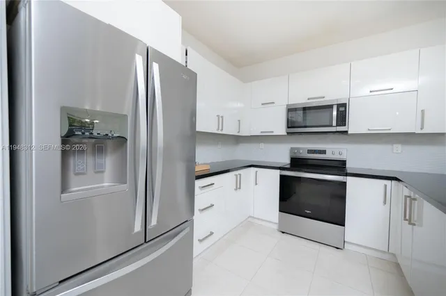 a kitchen with stainless steel appliances a sink stove and refrigerator