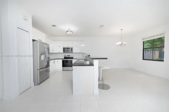 a bedroom with a bed and chandelier