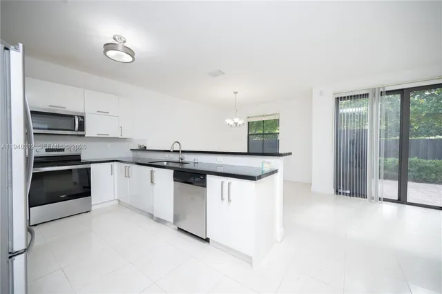 a view of a small space with wooden floor and a sink