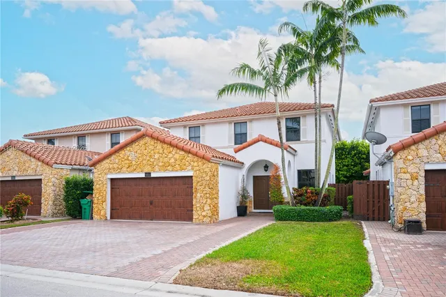 a front view of a house with a garden and entryway