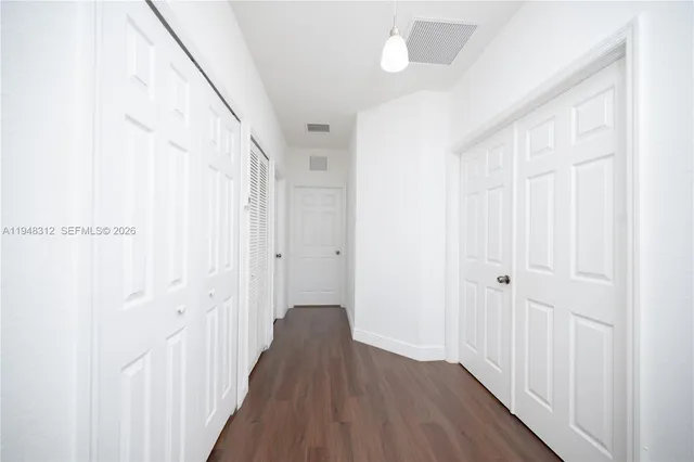 a view of a workspace with wooden floor