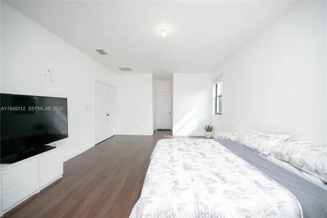 a view of a room with wooden floor