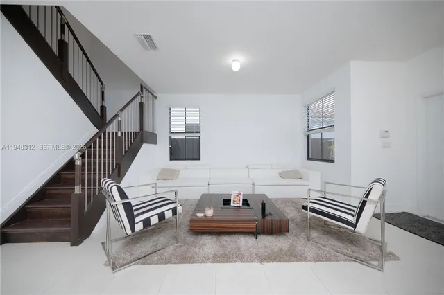 a living room with furniture and a piano