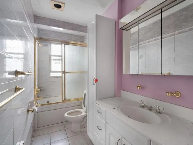 a bathroom with a granite countertop toilet a sink and a bathtub
