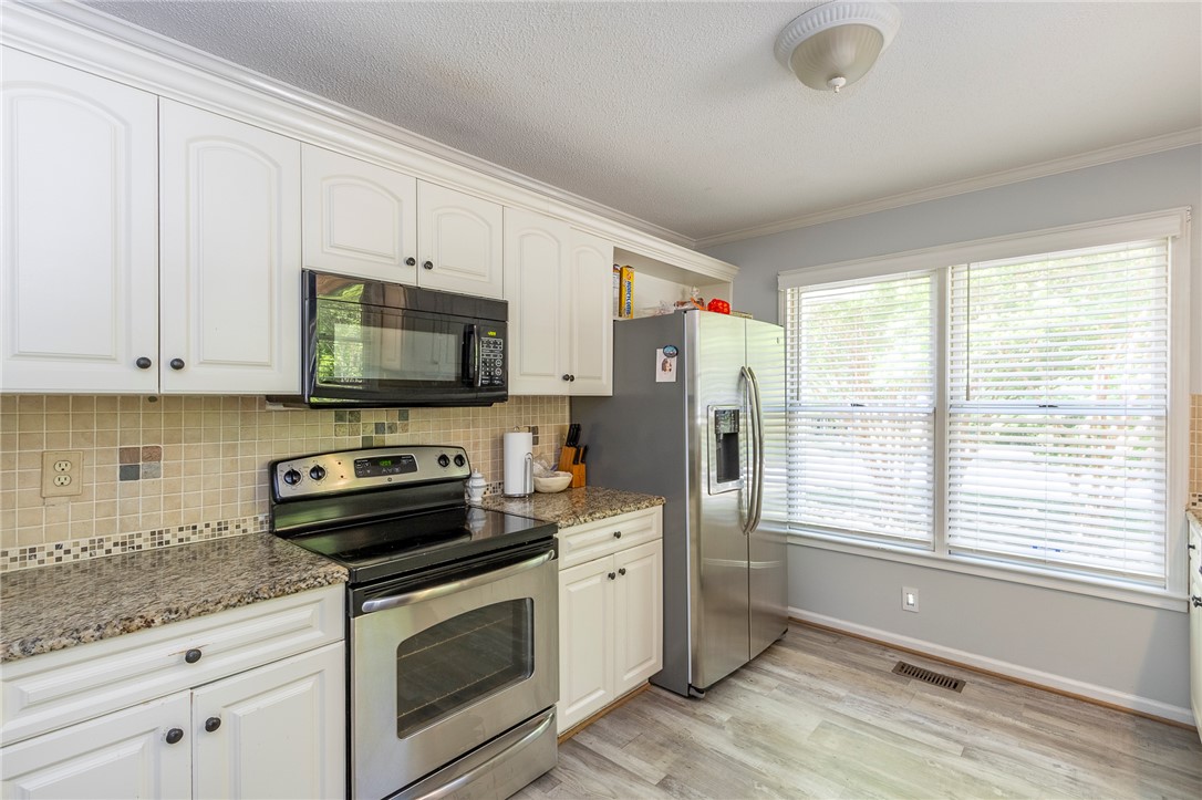151 Hannah Circle Anderson, SC 29621 - Photo 13 of 46 This kitchen showcases durable flooring, modern appliances, and ample counter space for daily living.