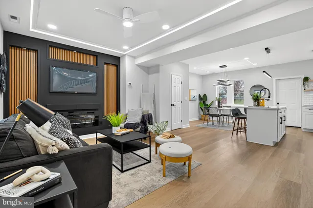 a living room with furniture and wooden floor