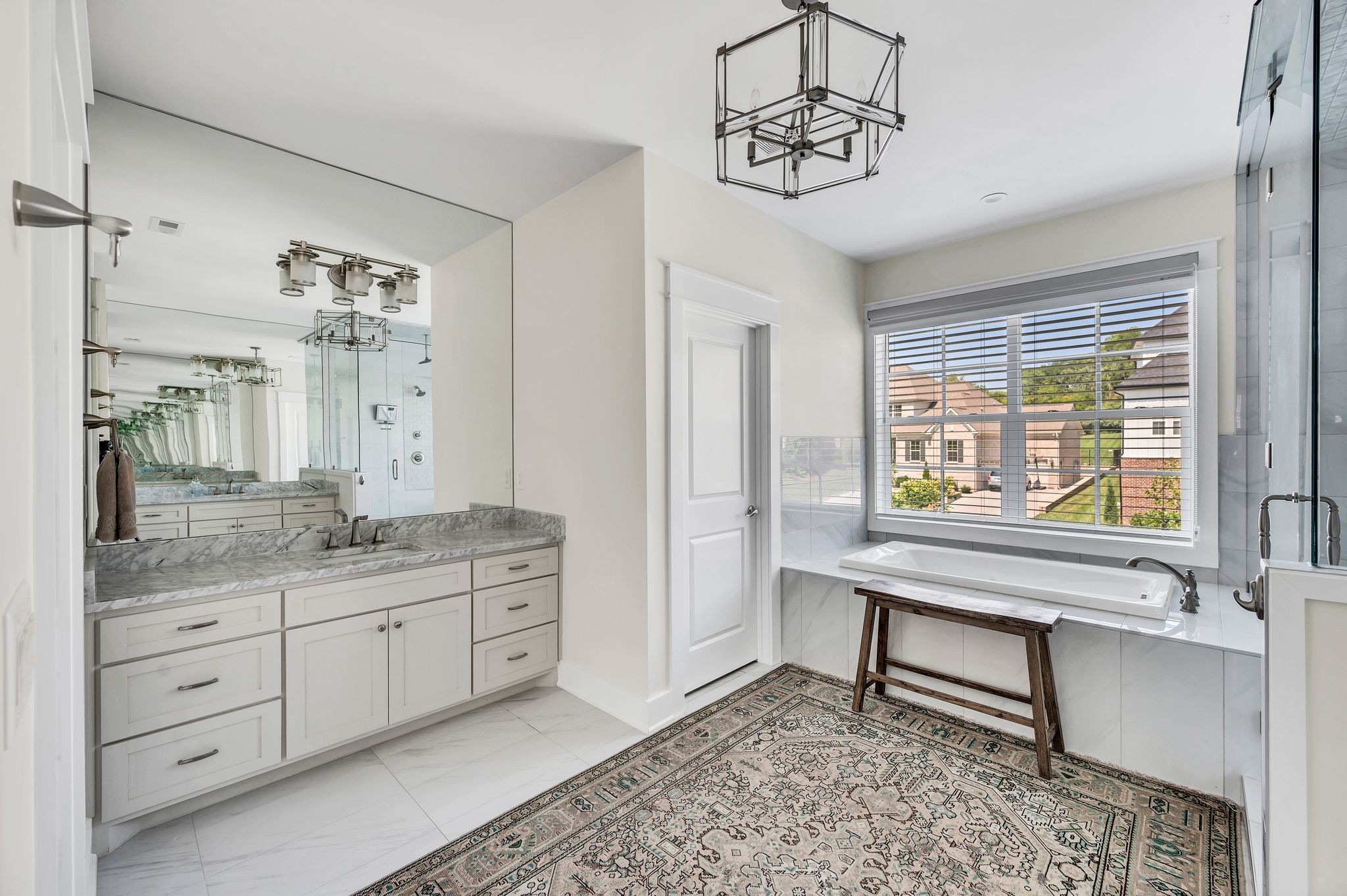 2156 Hartland Road Franklin, TN 37069 - Photo 38 of 63 a spacious bathroom with a granite countertop sink a mirror and a bathtub
