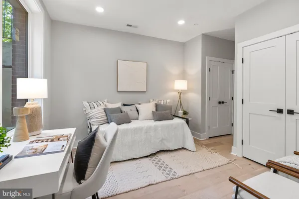 a bedroom with a bed and a mirror