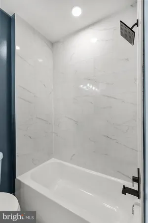 a bathroom with a bathtub and shower