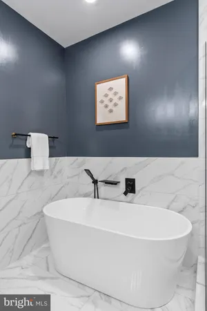 a white bath tub sitting in a bathroom