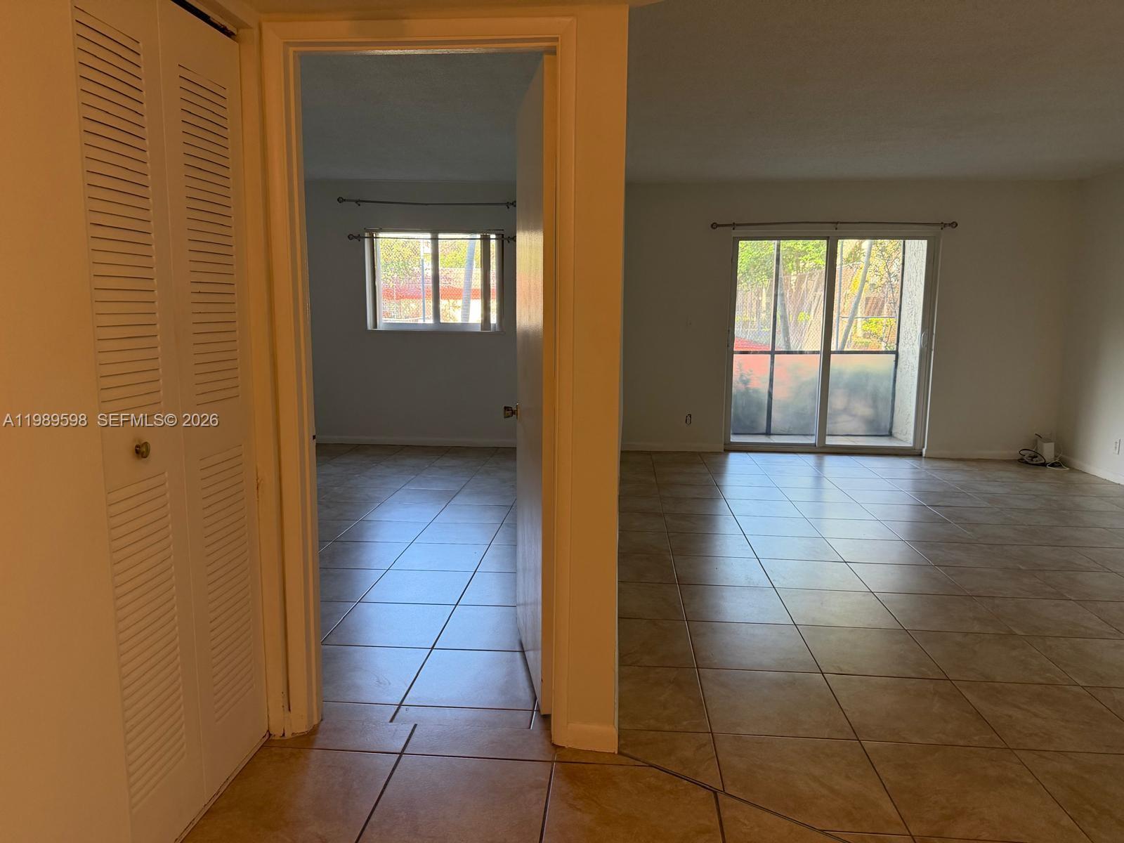 253 South Cypress Road, Unit 214 Pompano Beach, FL 33060 - Photo 10 of 25 a view of a hallway to an empty room and window