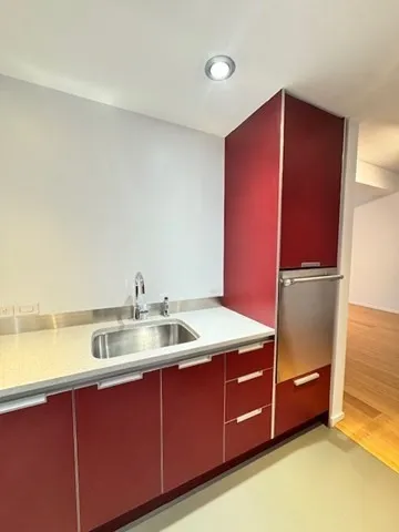 a kitchen with a refrigerator and a sink
