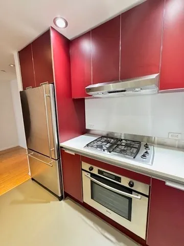 a stove top oven sitting inside of a kitchen