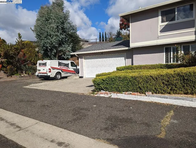 a view of a car park in front of house