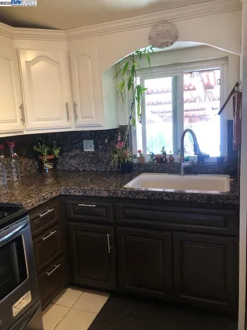 a kitchen with stainless steel appliances granite countertop a refrigerator and a stove