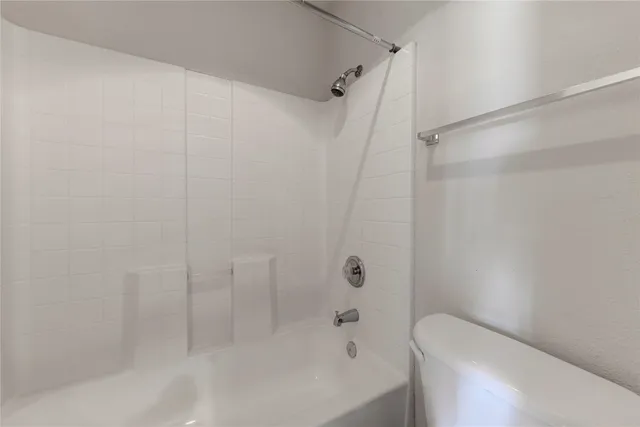 a bathroom with a bathtub and a toilet