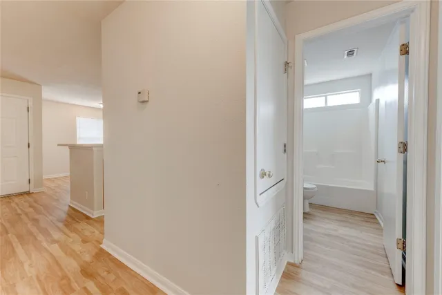 a view of a bathroom from a hallway
