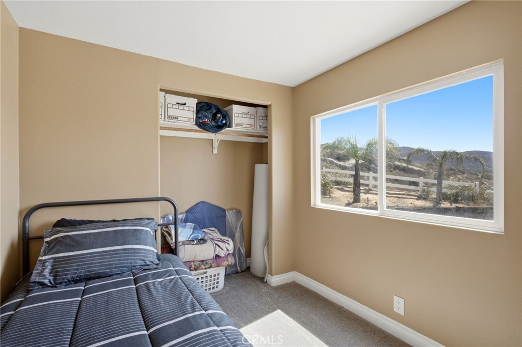40100 Owl Valley Road Temecula, CA 92592 - Photo 22 of 44 a room with a bed and a window