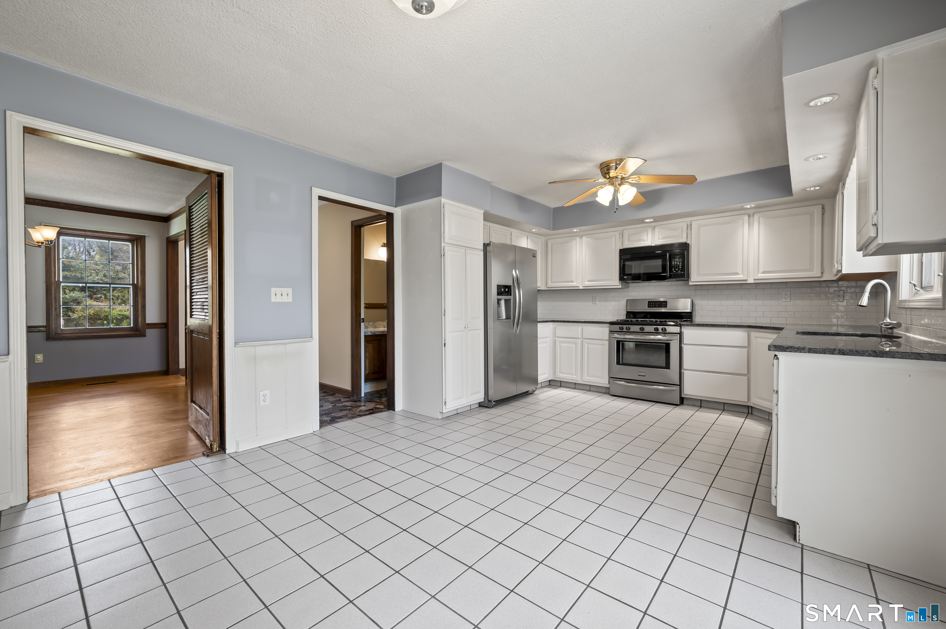 117 Charter Oak Road Southbury, CT 06488 - Photo 12 of 40 a kitchen with stainless steel appliances a refrigerator and a stove top oven