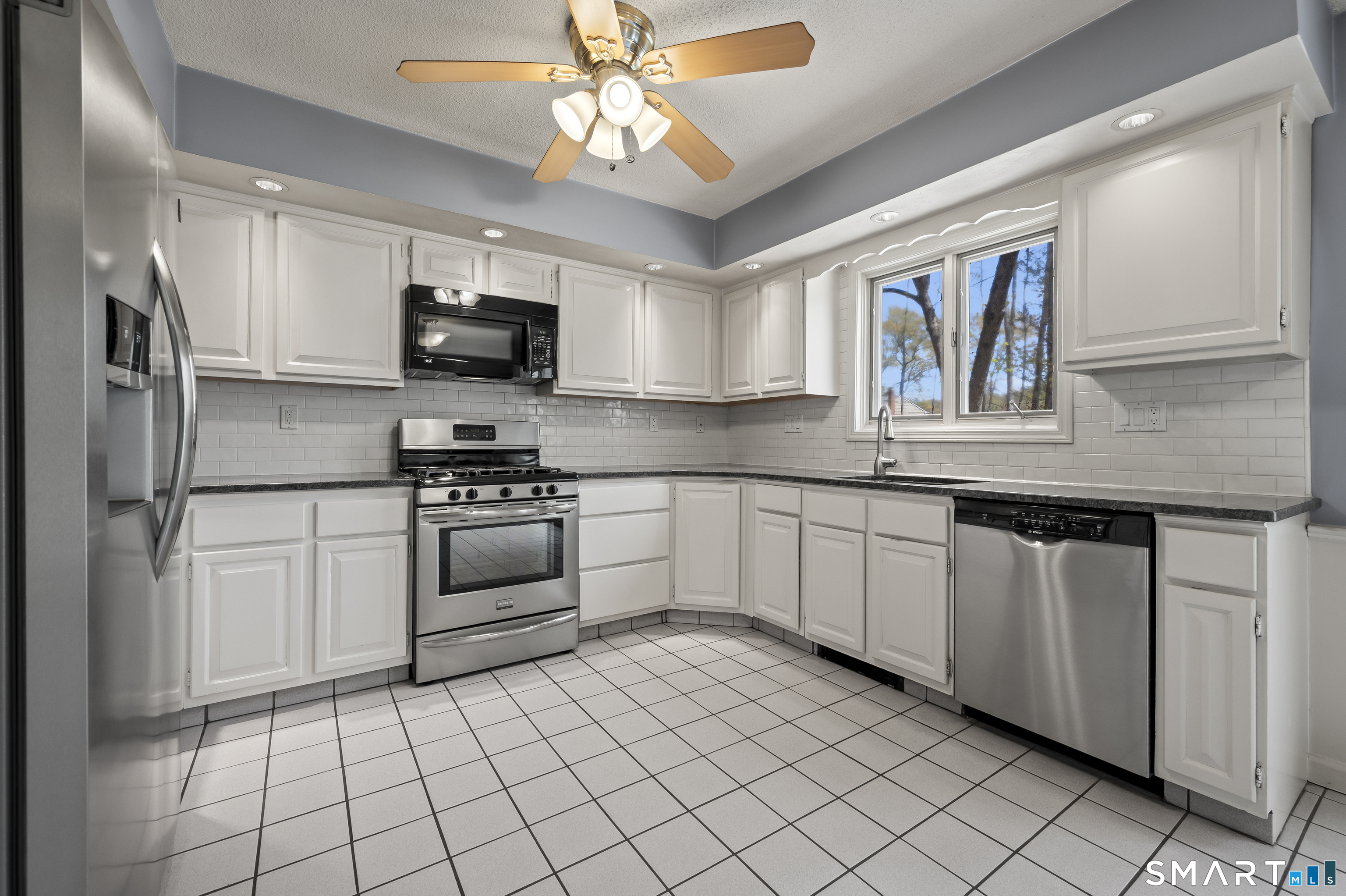 117 Charter Oak Road Southbury, CT 06488 - Photo 13 of 40 a kitchen with stainless steel appliances granite countertop a stove a sink and a refrigerator