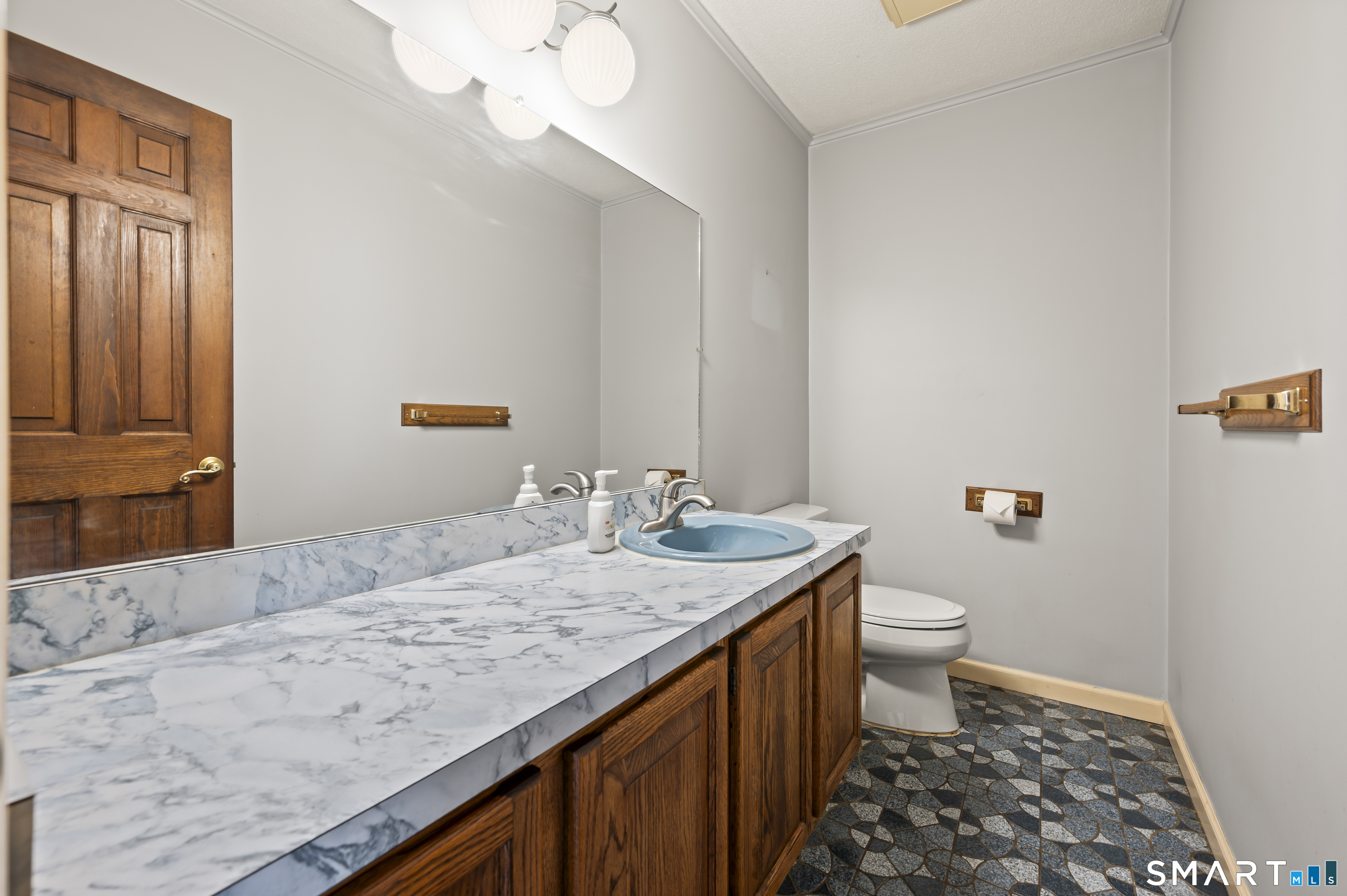 117 Charter Oak Road Southbury, CT 06488 - Photo 17 of 40 a bathroom with a granite countertop sink a toilet and a mirror