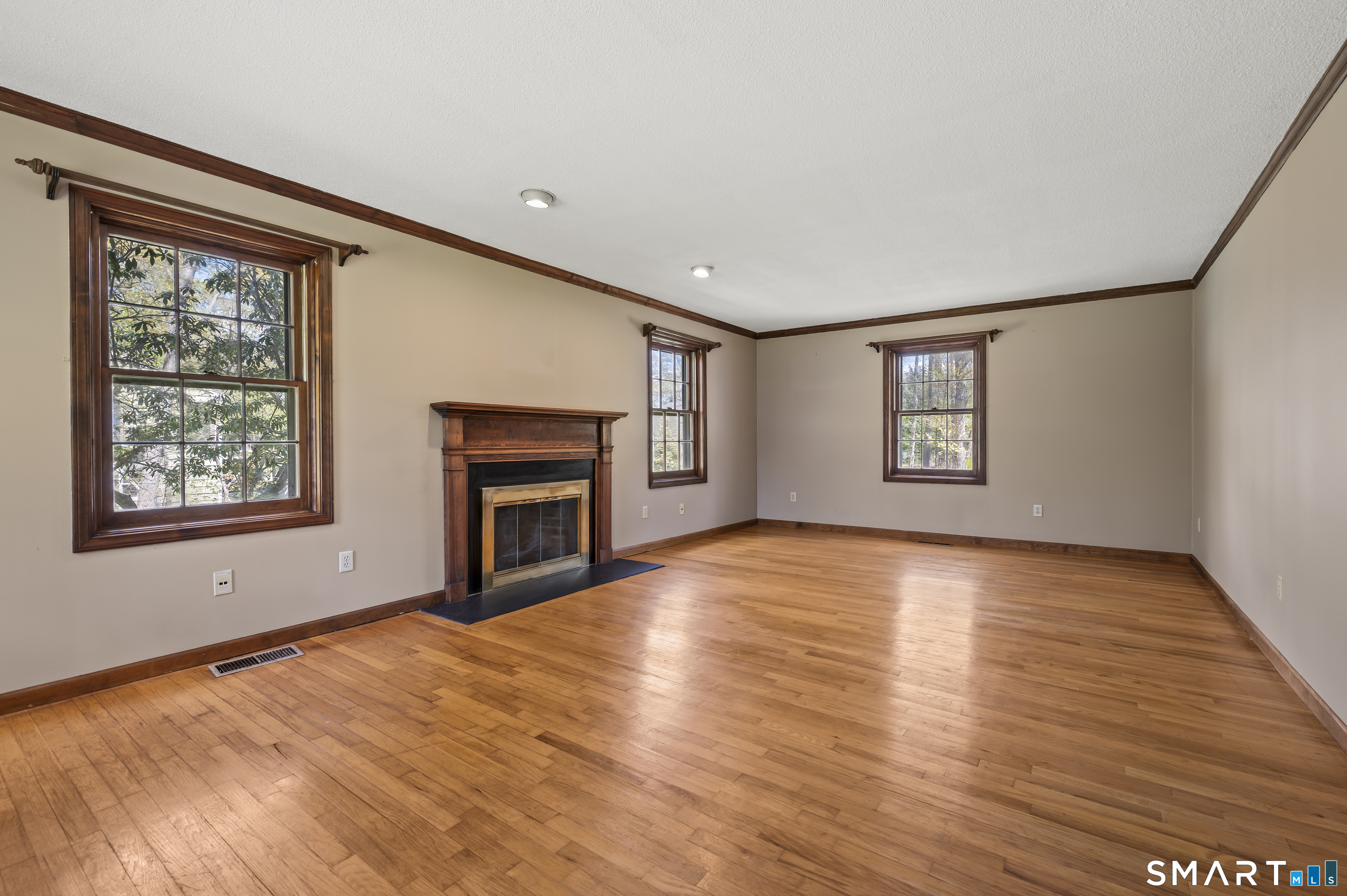 117 Charter Oak Road Southbury, CT 06488 - Photo 18 of 40 an empty room with windows and fireplace