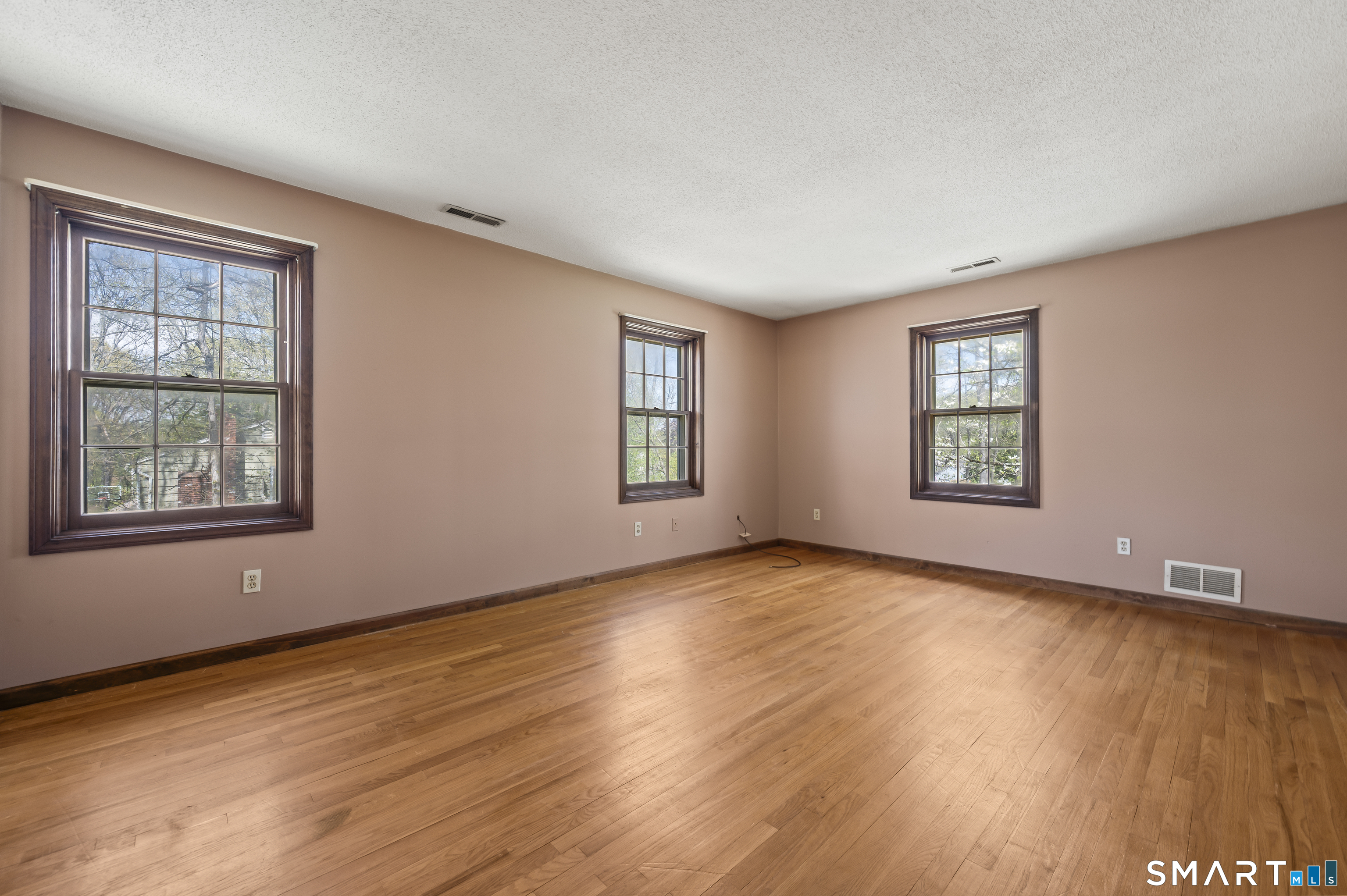 117 Charter Oak Road Southbury, CT 06488 - Photo 22 of 40 a view of an empty room with window and wooden floor