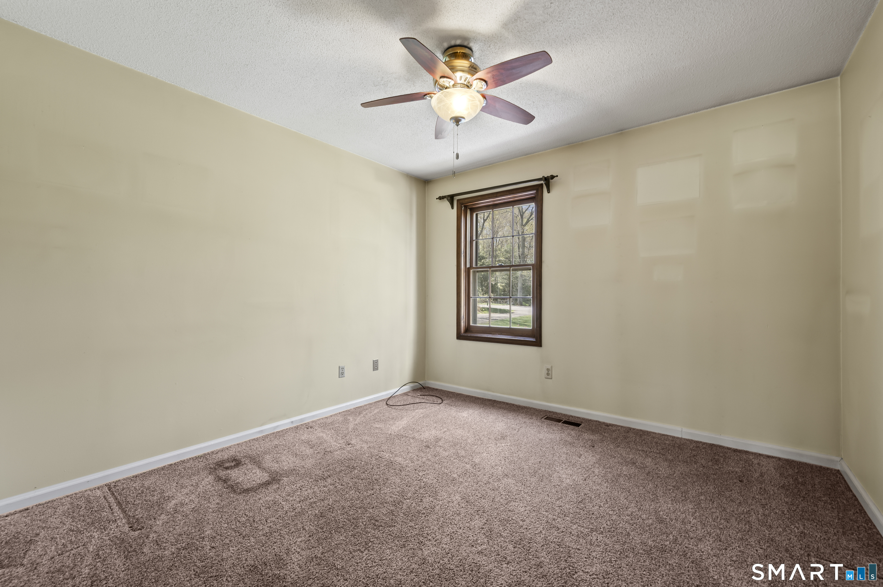 117 Charter Oak Road Southbury, CT 06488 - Photo 9 of 40 an empty room with windows and fan