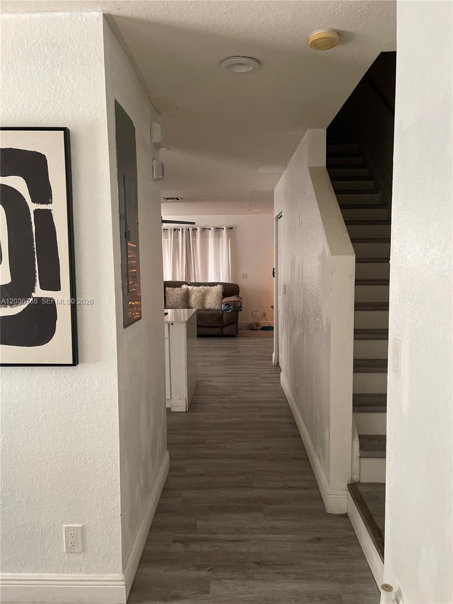 2432 Southwest 99th Way Miramar, FL 33025 - Photo 13 of 17 a view of a hallway with wooden floor and staircase