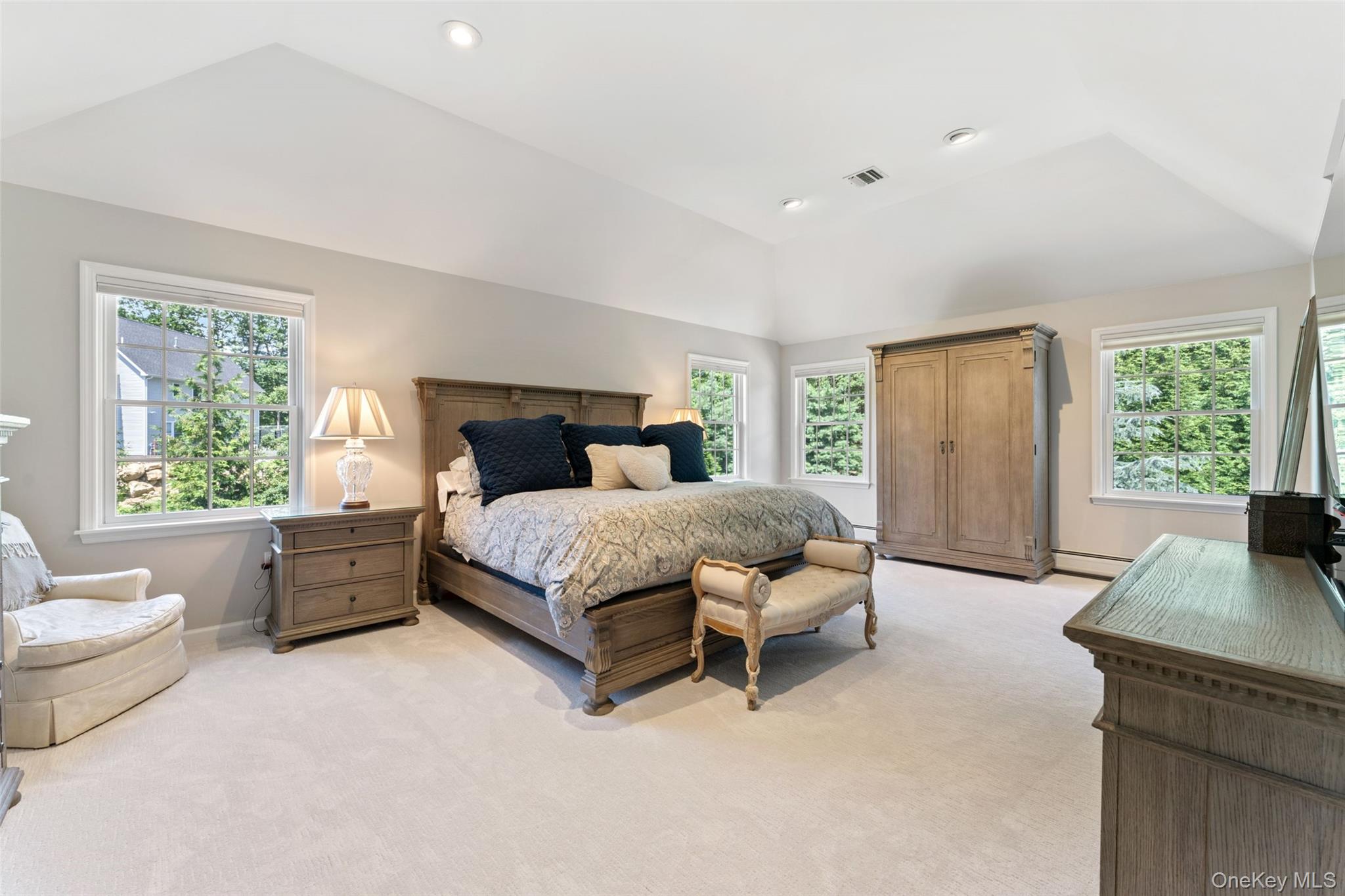 22 Perrin's Peak Road Stony Point, NY 10980 - Photo 37 of 47 Bedroom featuring multiple windows, vaulted ceiling, light carpet, recessed lighting, and a baseboard radiator