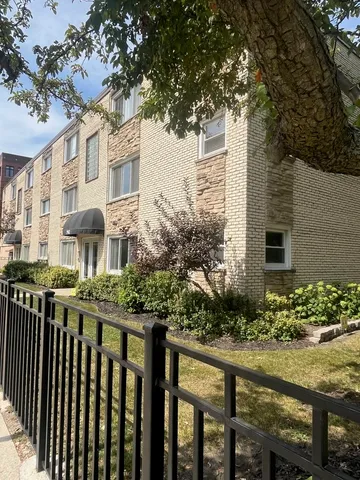 a view of a house with brick walls