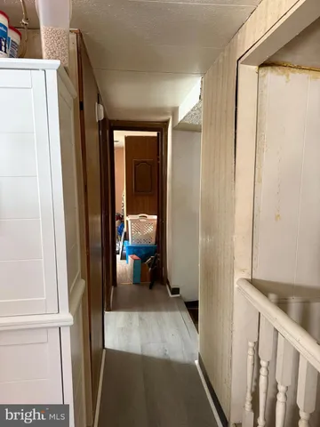 a view of a hallway and a livingroom with furniture