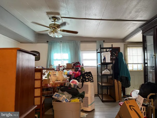 a living room with furniture chandelier and a window