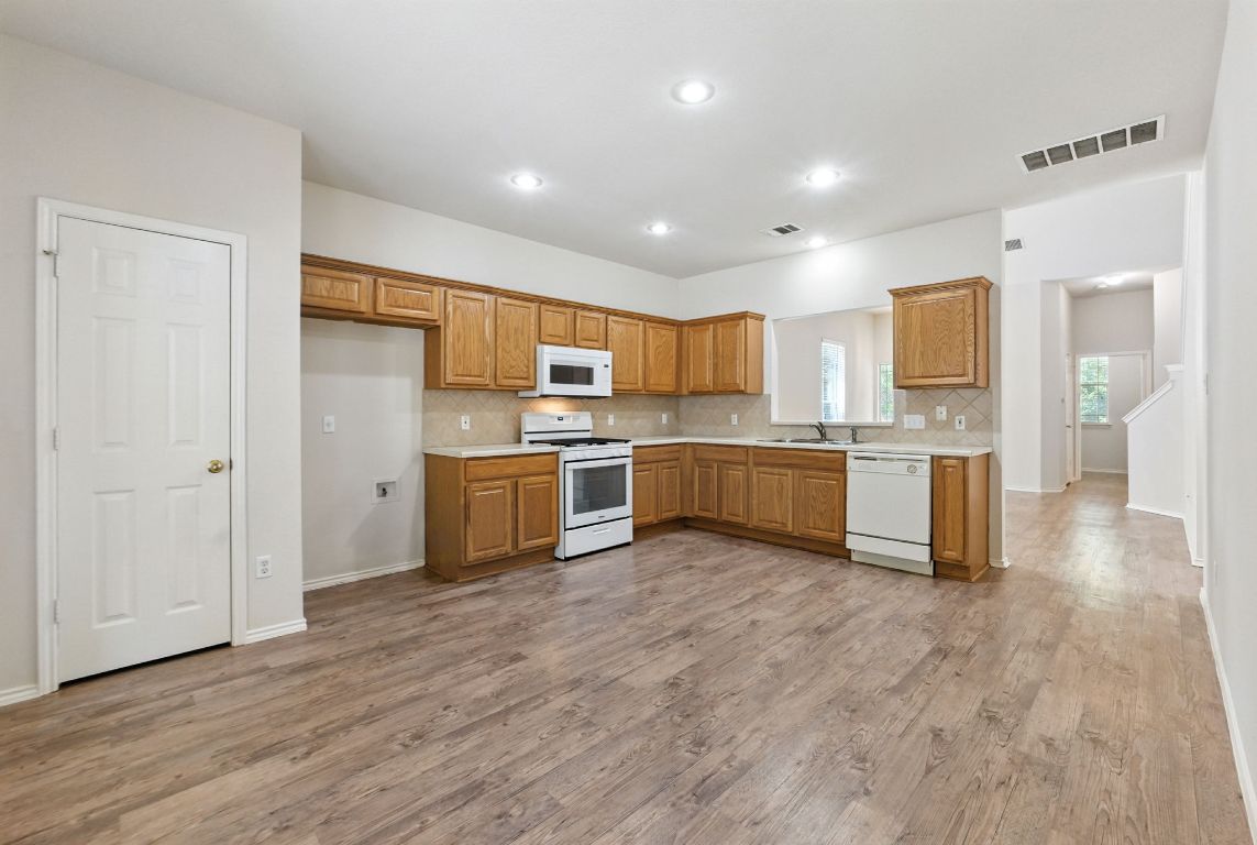 1114 Peyton Place Cedar Park, TX 78613 - Photo 12 of 39 a kitchen with stainless steel appliances a refrigerator and a stove top oven