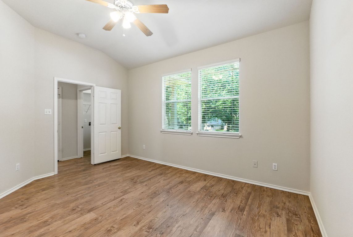 1114 Peyton Place Cedar Park, TX 78613 - Photo 15 of 39 a view of an empty room with wooden floor and a window