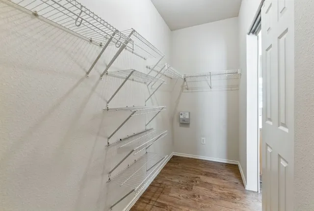 an empty room with a bathroom and a ceiling fan