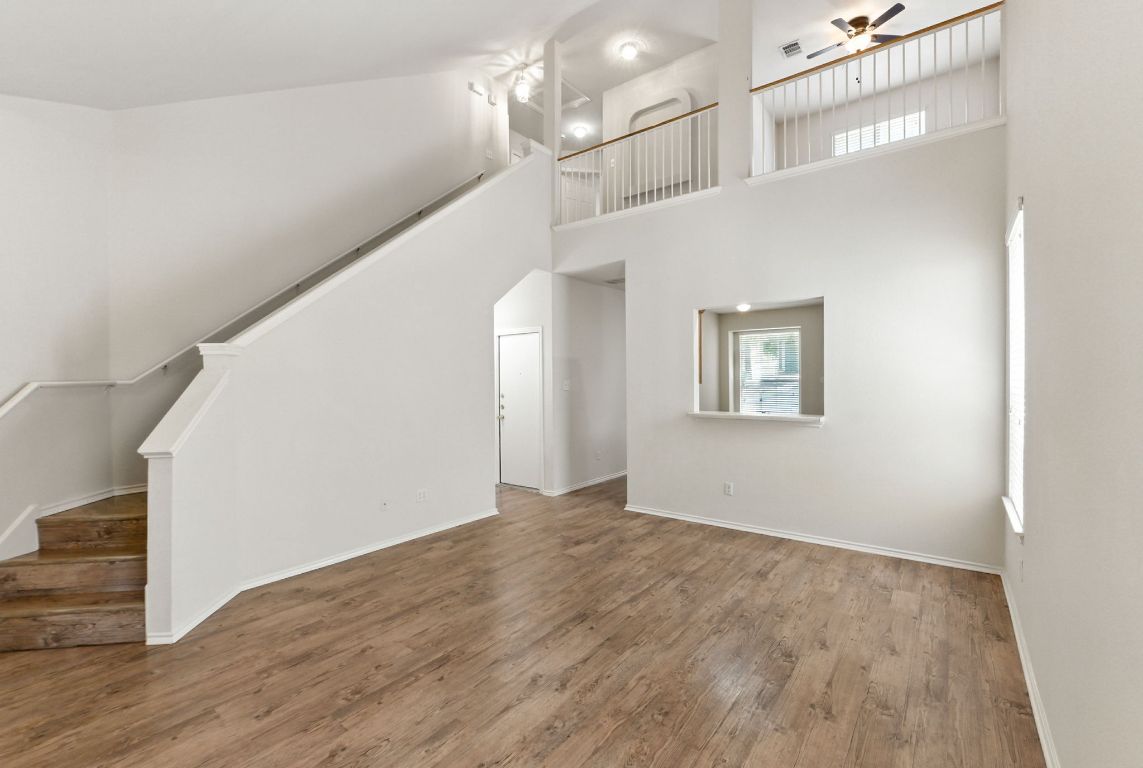 1114 Peyton Place Cedar Park, TX 78613 - Photo 6 of 39 a view of a hallway with wooden floor and staircase